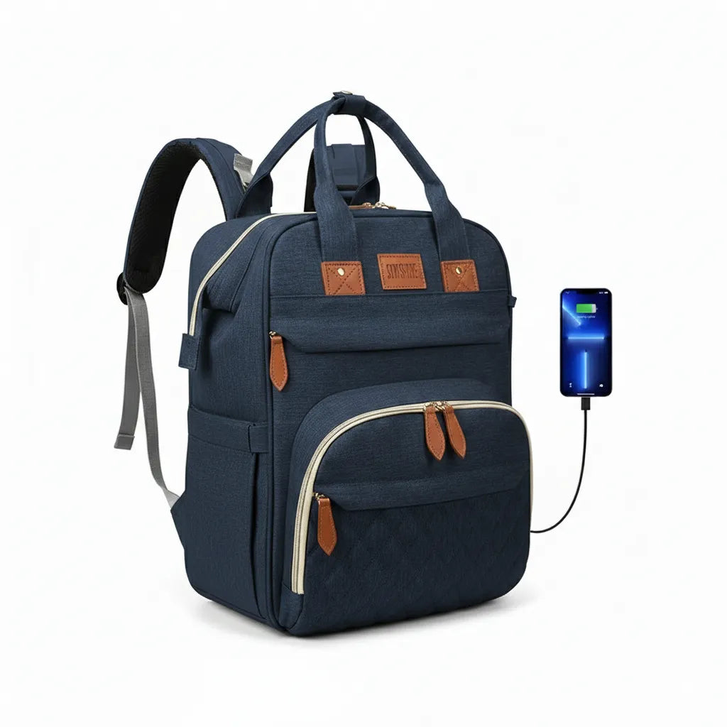 Sac à dos à langer bleu nuit multifonction avec port USB externe pour recharge téléphone, finitions effet cuir et poches isothermes.