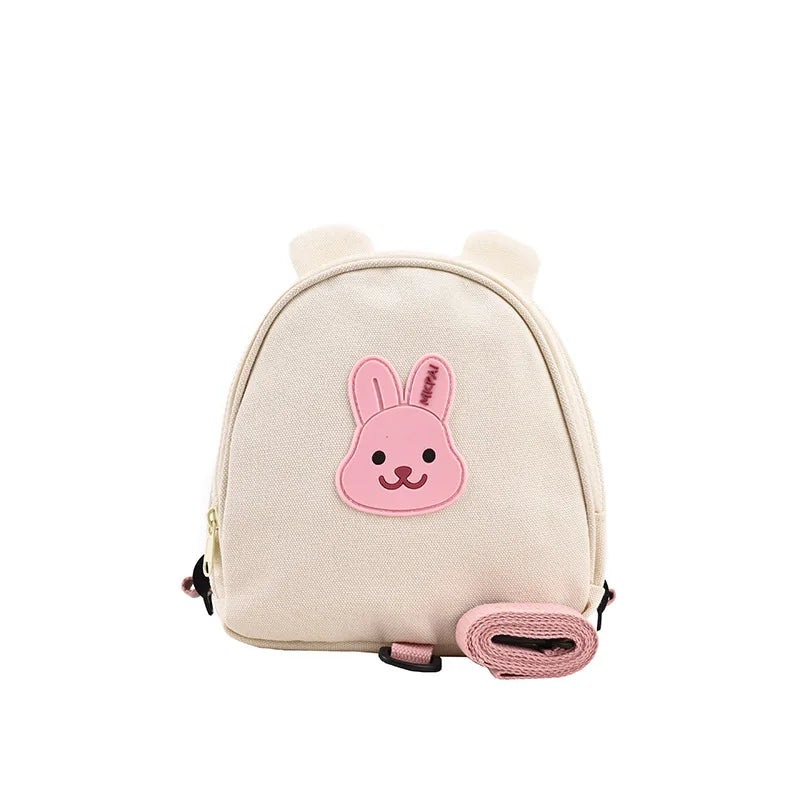 Mini sac à dos bébé lapin en nylon crème avec oreilles 3D, badge ourson en relief et laisse de sécurité détachable, vue de face