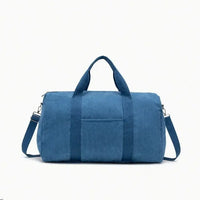 Sac à langer en velours côtelé bleu pétrole avec bandoulière réglable à mousquetons, poignées rigides et poche extérieure - format tote bag spacieux et élégant