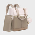 sac a dos a langer beige et blanc ergonomique sur fond gris