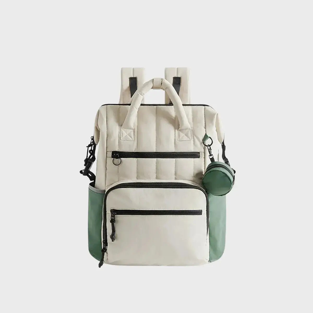 Sac à dos à langer beige et vert avec poches zippées avant, compartiments latéraux et petite pochette ronde amovible, idéal pour organiser les affaires de bébé