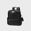 Sac à dos à langer en cuir PU noir avec poche frontale zippée, poches latérales et bretelles rembourrées, format structuré pour sorties avec bébé.