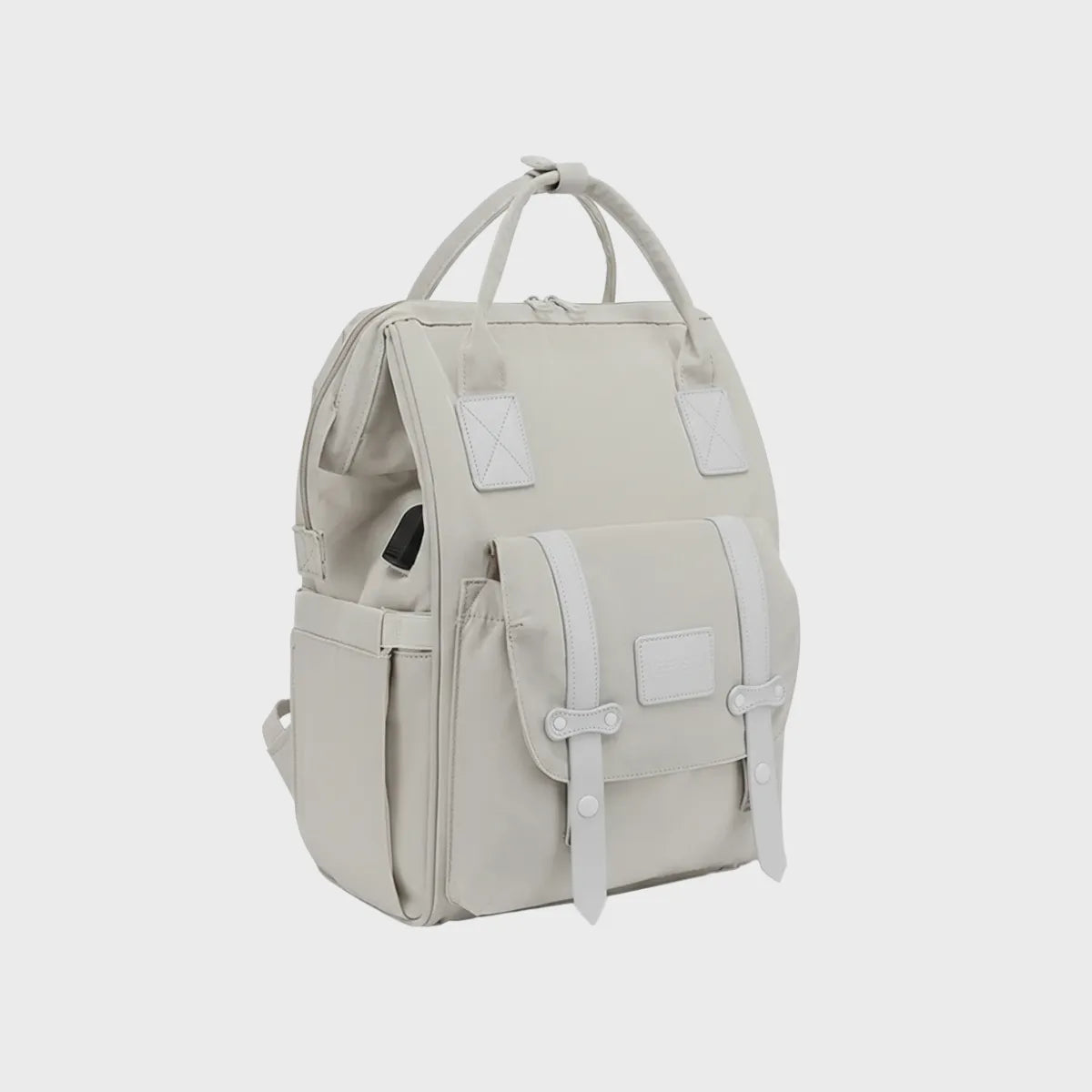 Sac à dos à langer beige avec 13 poches de rangement, port USB intégré et sangles de fermeture élégantes.