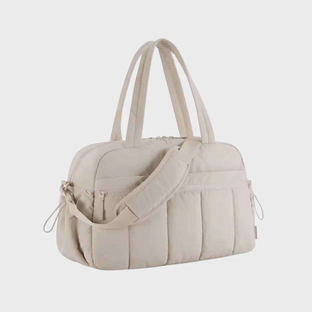 Sac à langer bandoulière beige en nylon, format compact avec poignées doubles et sangle amovible