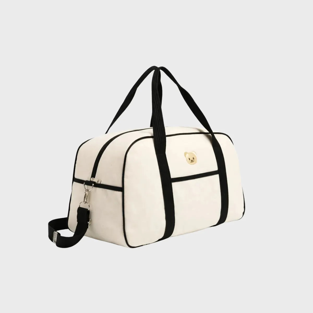 sac de maternite bébé écru avec sangles noires, vu de trois quarts sur fond blanc